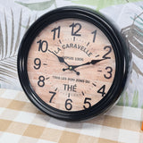 Round clock with wooden design and black frame on a patterned surface. metal wall clocl vintage 300mm