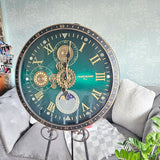 Decorative clock with intricate design on a stand in a living room setting Decorative clock with intricate design on a stand in a living room setting metal 600mm wide moving gears