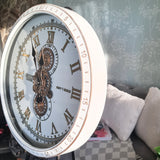Decorative wall clock with Roman numeral design on a light background