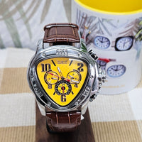Heart-shaped watch with brown leather strap and yellow face on a wooden surface.