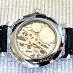 Mechanical watch with visible gears on a textured background