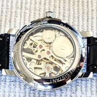 Mechanical watch with visible gears on a textured background