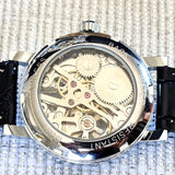 Mechanical watch with visible gears on a textured background