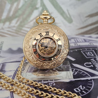Gold pocket watch with chain on a background of money