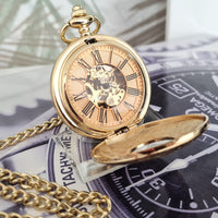 Gold pocket watch with chain on a textured surface