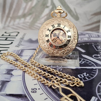 Gold pocket watch with chain on a magazine background