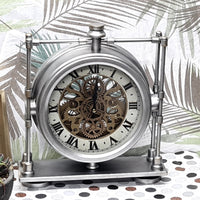 Decorative clock with metal frame and visible gears on a patterned surface