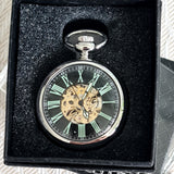 Pocket watch with green Roman numerals in a black box
