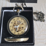 Vintage pocket watch with chain in a black box on a textured fabric background
