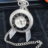 Silver pocket watch with chain on a black background