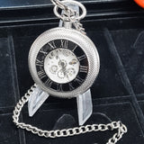 Silver pocket watch with chain on a black background