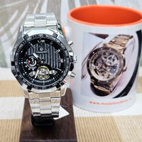 Watch with brown leather strap and visible mechanical components on a white cushion
