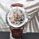 Watch with brown leather strap and transparent face on a blurred background