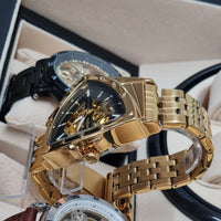 Gold wristwatch with intricate design in a box