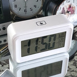 white digital alarm clock